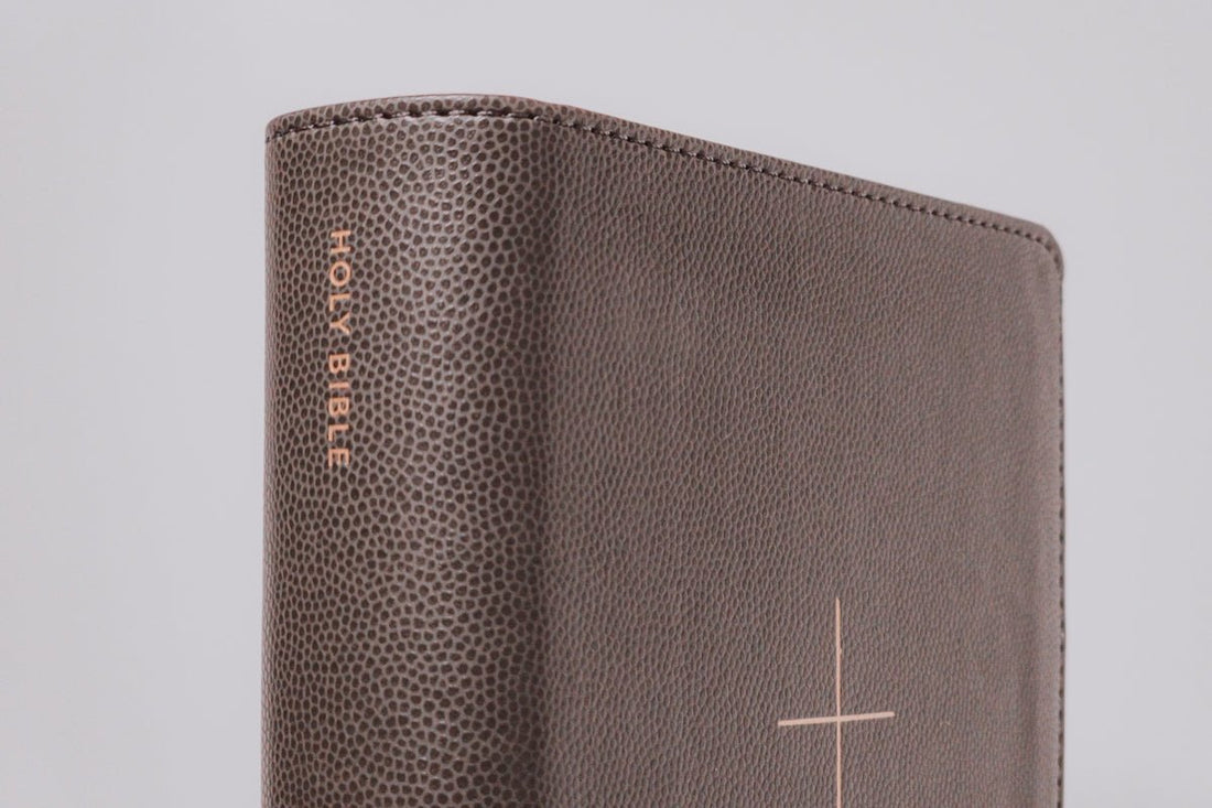 A closed holy bible with a cross design.